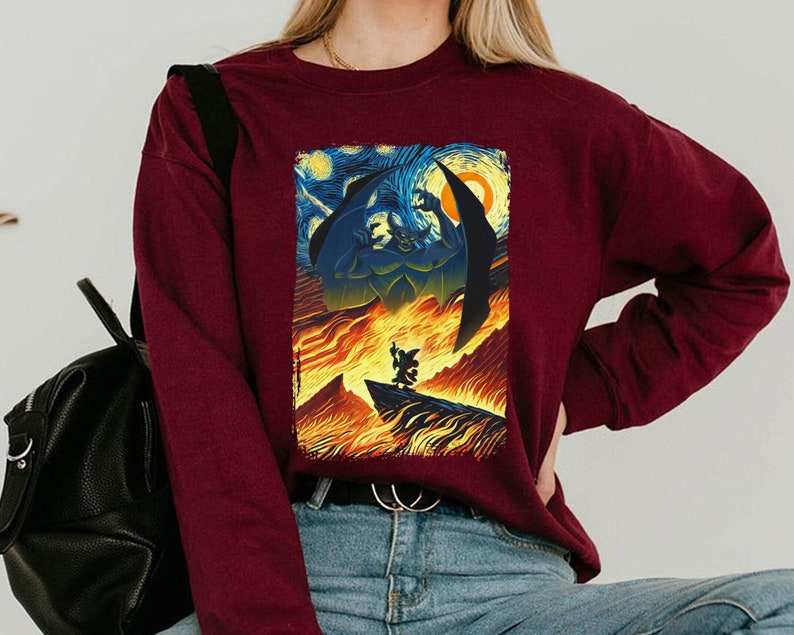 May include: A maroon long-sleeve sweatshirt with a graphic print of a scene from the movie "The Nightmare Before Christmas". The print features Jack Skellington and Sally in a fiery landscape inspired by Vincent van Gogh's "Starry Night".