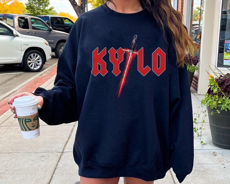 May include: Black sweatshirt with a red graphic of a lightsaber and the word "KYLO" in red block letters.