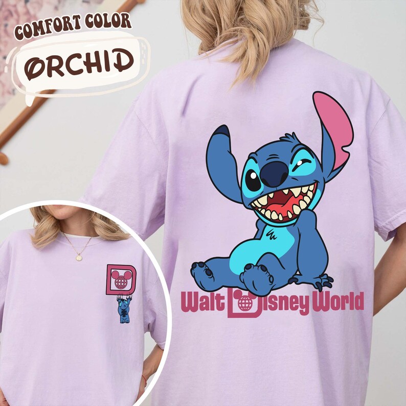 May include: Orchid-colored t-shirt featuring a cartoon Stitch character from Disney's Lilo & Stitch. The back of the shirt displays a large Stitch graphic with the words "Walt Disney World." The front of the shirt has a small Stitch graphic and the letter "D".