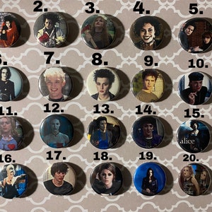 May include: Twenty round button pins featuring characters from the movie "Beetlejuice". The pins are arranged in a grid of four rows and five columns. Each pin has a white background with a black border and a number from 1 to 20 printed in the top left corner.