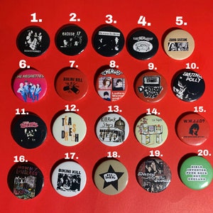 May include: Twenty black and white, red, and beige round buttons with band names and logos. The buttons are numbered 1 through 20.