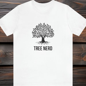 May include: White t-shirt with a black tree graphic and the text "TREE NERD" printed on the front.