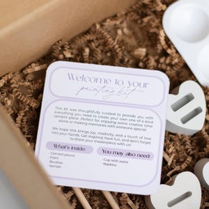 May include: A craft kit with instructions for creating a cement piece. The kit includes cement, paint, brushes, varnish, and a small white tray with four compartments. The instructions include a list of what's inside the kit and what you may also need.