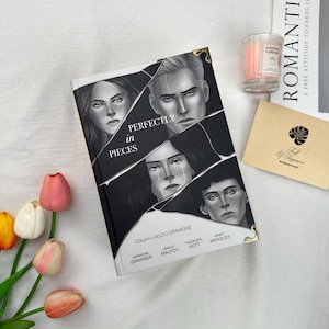 May include: A book titled "Perfectly in Pieces" with character illustrations on the cover. The book is black and white, with the title in large white letters. A small candle and a card are also in the image.