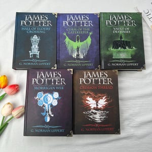 May include: Five hardcover books titled "James Potter" with different subtitles: "Hall of Elders' Crossing", "Curse of the Gatekeeper", "Vault of Destinies", "Morrigan Web", and "Crimson Thread". Each book has a unique cover design and the author's name, G. Norman Lippert.