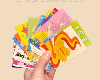 May include: A set of colourful grounding cards with phrases such as "Talk About It In Ther-hippie" and "Relax The Muscle Bottom" printed on them. The cards are held in a hand.
