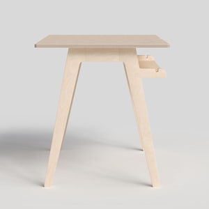 May include: A light wood desk with a simple design and a small shelf underneath the desktop.