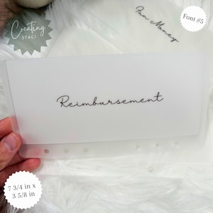 May include: A white plastic sheet with holes along the bottom edge. The sheet has the word "Reimbursement" written in black cursive font. The sheet measures 7 3/4 inches by 3 5/8 inches.