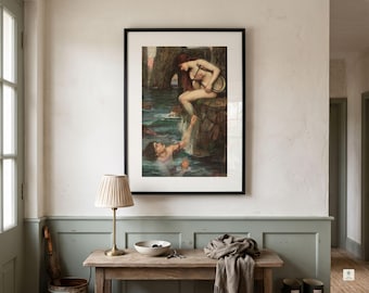 May include: A framed art print depicting a mythological scene with a figure sitting on a rocky shore reaching down to a person in the water. The artwork features dark, earthy tones of brown, green, and blue, enclosed in a simple black frame.