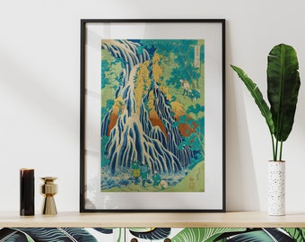 May include: A framed print of a Japanese woodblock print depicting a waterfall with a mountain in the background. The print is in shades of blue, green, and yellow. There are small figures of people in the foreground.