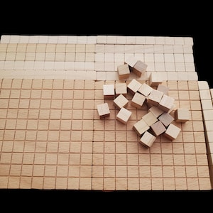 May include: A set of wooden blocks in various sizes, arranged on a wooden grid. The blocks are all natural wood color and are arranged in a random pattern.