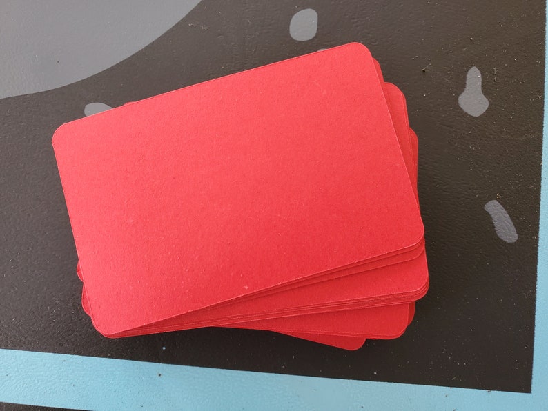 May include: A stack of red cardstock paper.