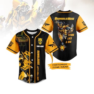 Puede incluir: Camiseta de béisbol negra y amarilla con Bumblebee de Transformers. La camiseta tiene una parte delantera abotonada, mangas amarillas y el texto "Bumblebee" y "Sting Like a Bee". La parte delantera dice "Bumblebee, Let's Roll Out!" y "Customize Your Name".