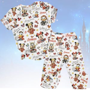 May include: White pajama set with a pattern of Disney characters as Avengers. The set includes a short-sleeved top and trousers. Characters include Mickey Mouse, Minnie Mouse, Donald Duck, and Goofy. The word "Avengers" is also visible.
