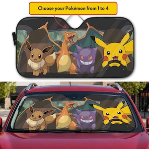 May include: A car windshield sunshade featuring a graphic print of Eevee, Charizard, Gengar, and Pikachu sitting in car seats. The text "Choose your Pokémon from 1 to 4" is printed at the top. The sunshade is shown installed in a red vehicle.