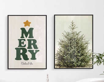 May include: Two framed prints of Christmas trees. One print features a green Christmas tree with the word "MERRY" spelled out in green letters. The other print features a green Christmas tree with a white background.