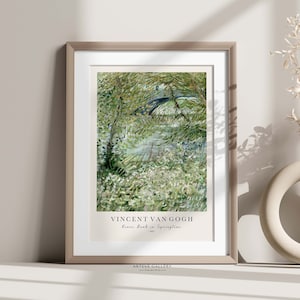 May include: A framed print of a painting by Vincent van Gogh titled "The Drawbridge in Springtime" depicting a green landscape with a bridge and trees in a brushstroke style.