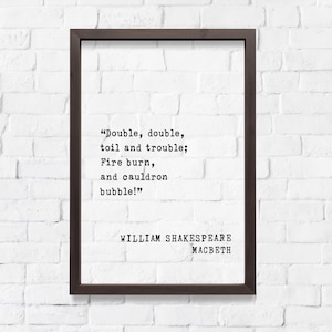 May include: A framed print with the quote "Double, double, toil and trouble; Fire burn, and cauldron bubble!" by William Shakespeare from Macbeth. The text is in a typewriter font, set against a white background, and framed in a dark brown frame.
