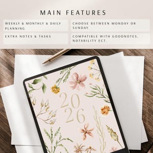 May include: Digital planner for 2026 with floral design. Features include weekly, monthly, and daily planning, extra notes, and tasks. Compatible with Goodnotes, Notability, etc. The planner has a light pink background with flowers and the numbers 2026.