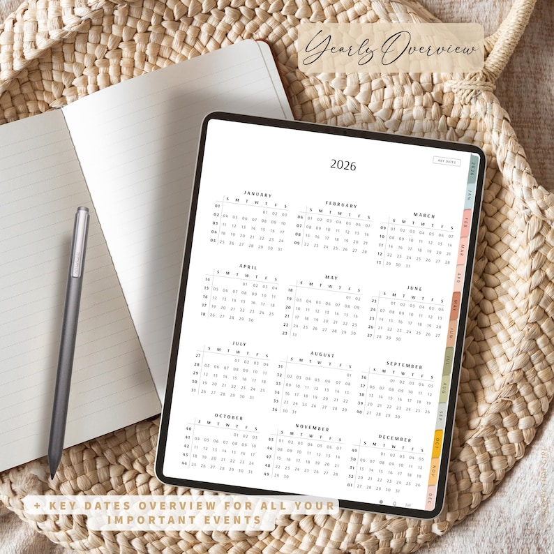 May include: A digital planner for 2026 displayed on a tablet, with a yearly overview calendar. The tablet is open to a page with the months of the year. A notebook and stylus are next to the tablet. Text on the image says "Yearly Overview" and "+ Key Dates Overview for All Your Important Events."