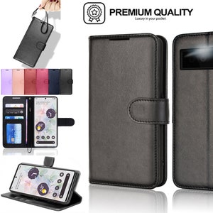 May include: A black leather phone case with a wallet flap and a card holder. The case has a magnetic closure and a strap for carrying. The case is designed for a smartphone with a camera on the back. The text "PREMIUM QUALITY Luxury in your pocket" is printed on the case.