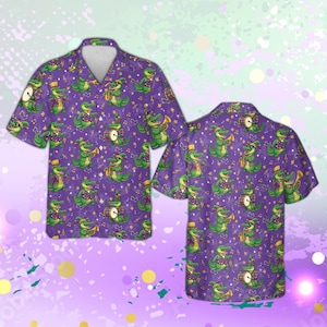 May include: Purple button-down shirt featuring a repeating pattern of green alligators playing musical instruments. The alligators wear purple vests and hats. Musical notes and stars are scattered across the fabric. The shirt has short sleeves and a classic collar.