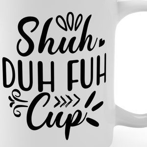 May include: White ceramic coffee mug with black text that reads "Shuh-Duh Fuh Cup!"