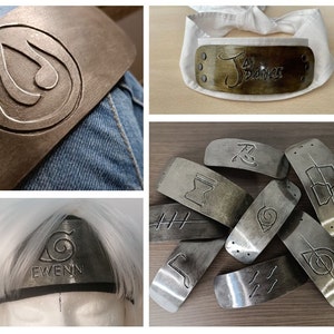 May include: A collection of ten metal headbands with different designs, including a swirl, a symbol, and the word "Ewenn".