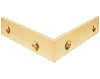 May include: A gold metal corner brace with three holes for screws. The brace is L-shaped and has a smooth, polished finish.