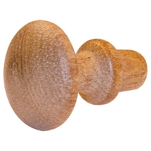 May include: A wooden knob with a mushroom-shaped top and a cylindrical base. The knob is a light brown colour and has a smooth, polished finish.