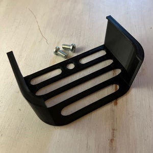 May include: Black plastic 3D printed bracket with four slots and two small silver screws.