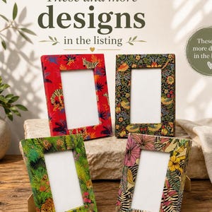 May include: Four decorative picture frames with colorful floral and animal print designs. The frames are rectangular with a white interior and are displayed on a stone surface. The text "These and more designs in the listing" is at the top.