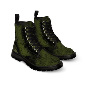 May include: A pair of green and black lace-up boots with a distressed, textured finish. The boots have a chunky sole and a rounded toe.