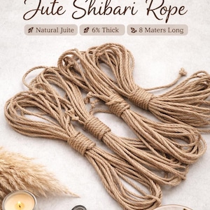 May include: Bundles of natural jute rope, 6% thick and 8 meters long, are displayed. The image features the text "Jute Shibari Rope" at the top. The rope is a light brown color and is bundled together with twine.