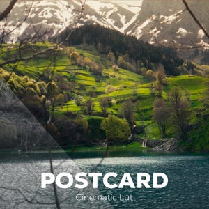 May include: A landscape photograph featuring a vibrant green hillside with trees and snow-capped mountains in the background, reflected in a blue lake. The text POSTCARD Cinematic Lut is overlaid in white at the bottom centre of the image.