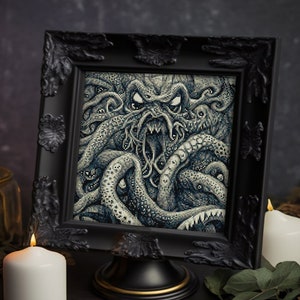 May include: A black framed picture with a detailed illustration of a monstrous, multi-tentacled creature with a gaping maw. The creature is depicted in shades of gray and blue, with a textured background. The picture is displayed on a black stand.