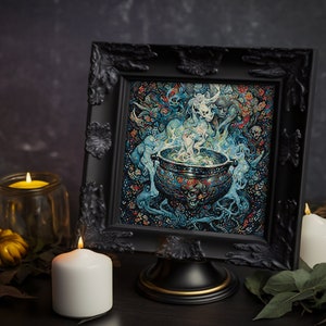 May include: A black framed picture with a detailed cross-stitch design of a cauldron with smoke and a ghostly figure. The picture is on a black stand with a gold trim. There are three candles in the image, two yellow and one white.