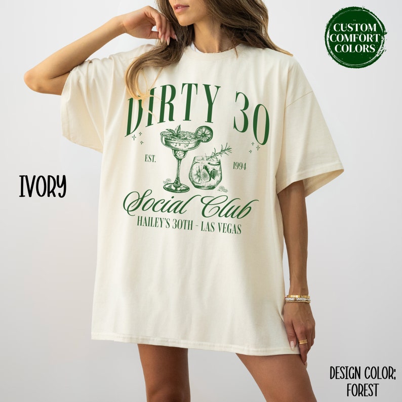 May include: A white t-shirt with the text "DIRTY 30" in green, with a design of two cocktails and the text "Social Club" in green. The text below the cocktails reads "EST. 1994" and "HAILEY'S 30TH - LAS VEGAS".