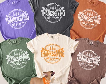 May include: A collection of six t-shirts in various colors, including purple, gray, orange, green, cream, and brown. Each shirt features a circular graphic with the text "Johnson Family Thanksgiving 2025" and a matching pet bandana.