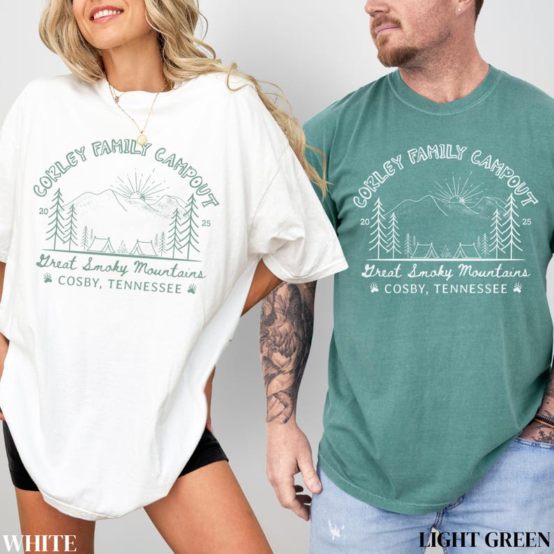 May include: White and light green t-shirts with a graphic design. The design includes the text "CORLEY FAMILY CAMPOUT" above an illustration of mountains, trees, and tents. Below the illustration is the text "Great Smoky Mountains, COSBY, TENNESSEE."