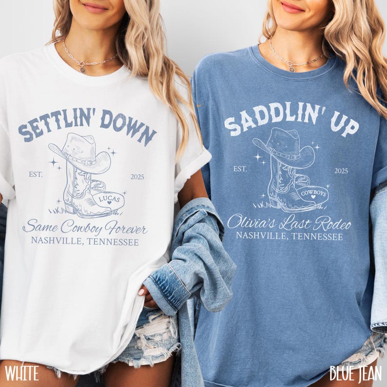 May include: Two white t-shirts with a blue graphic design of cowboy boots. The text on the shirts reads "Settlin' Down" and "Saddlin' Up".