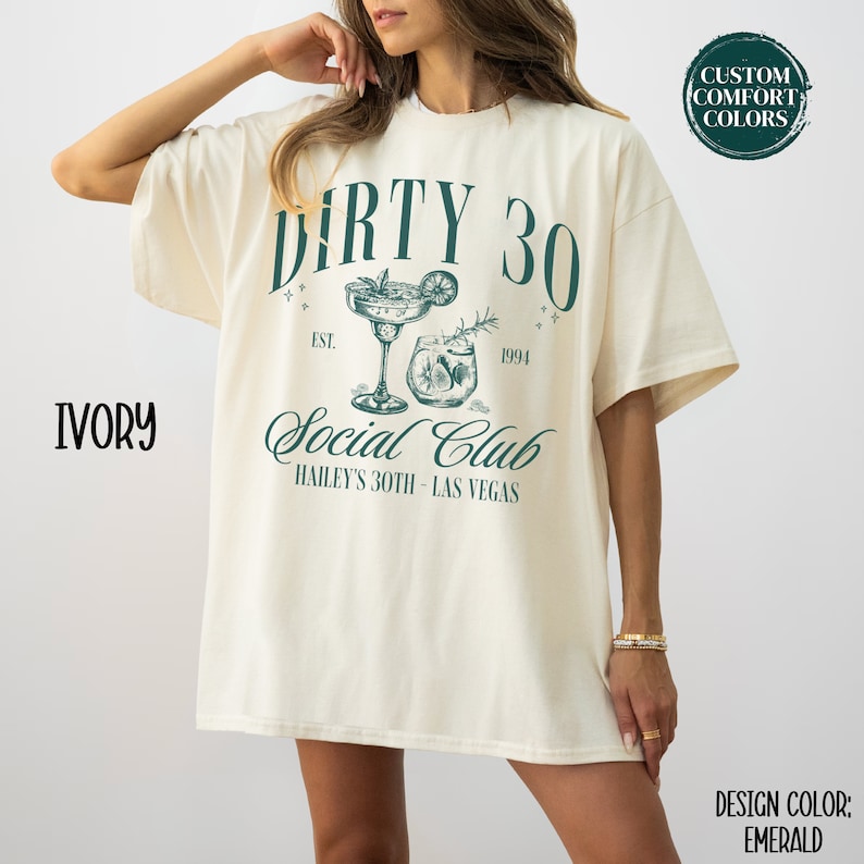 May include: Ivory t-shirt with a green graphic design that says "Dirty 30 Social Club Hailey's 30th - Las Vegas" with two cocktail glasses. The text "Est. 1994" is above the glasses.