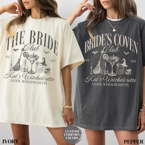 May include: Two oversized t-shirts with a vintage-inspired design. The ivory shirt says "The Bride Club" with a witch's broom, cauldron, and potion bottles. The gray shirt says "Bride's Coven Club" with the same design. Both shirts have the text "Kat's Witchelorette, Salem, Massachusetts" and the years "EST. 2024".