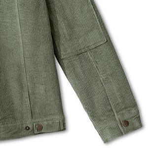May include: An olive green corduroy jacket featuring a textured ribbed fabric, a long sleeve with a reinforced elbow patch, a buttoned cuff, and a hemline with a metallic button closure. The garment displays vertical stitching and structured seams.