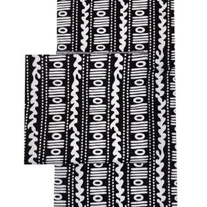 May include: Black and white patterned fabric with a repeating design of vertical lines, dots, and wavy shapes. The fabric is likely used for clothing or home decor items. The design is symmetrical and visually striking.
