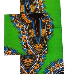 May include: Green fabric with a vibrant African print. The design features a central black panel with a detailed pattern in orange, blue, and yellow. The fabric is folded, showcasing the repeating pattern.