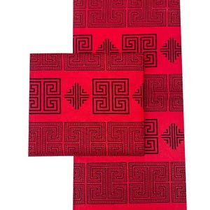 May include: Red fabric with a repeating black geometric pattern. The design features squares and rectangles with dotted and solid lines. The fabric is folded and arranged to show the pattern's continuity.