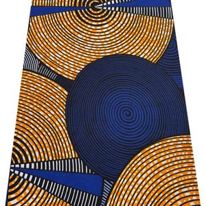 May include: A vibrant fabric featuring a bold pattern of orange and black concentric circles against a deep blue background. The design includes blue and white geometric shapes, creating a striking visual contrast. This textile is suitable for various crafting projects.