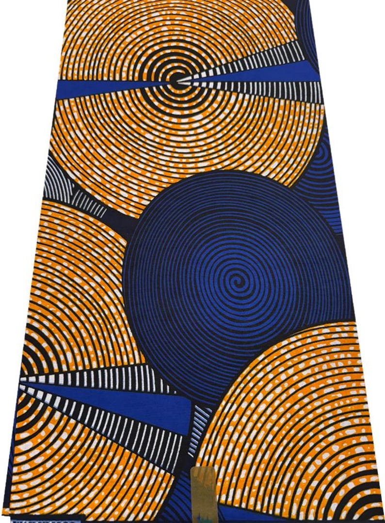May include: A vibrant fabric featuring a bold pattern of orange and black concentric circles against a deep blue background. The design includes blue and white geometric shapes, creating a striking visual contrast. This textile is suitable for various crafting projects.