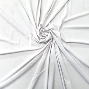 May include: White fabric backdrop with a smooth, wrinkle-free texture. The fabric is gathered in the center, creating a swirling pattern.